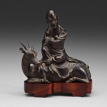 27. A bronze figure of Sholou on a reclining deer, Qing dynasty (1644-1912).