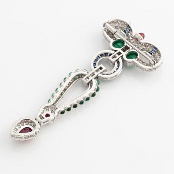 Brooch, white gold with cabochon-cut emeralds, rubies, sapphires, and brilliant- and square-cut diamonds.