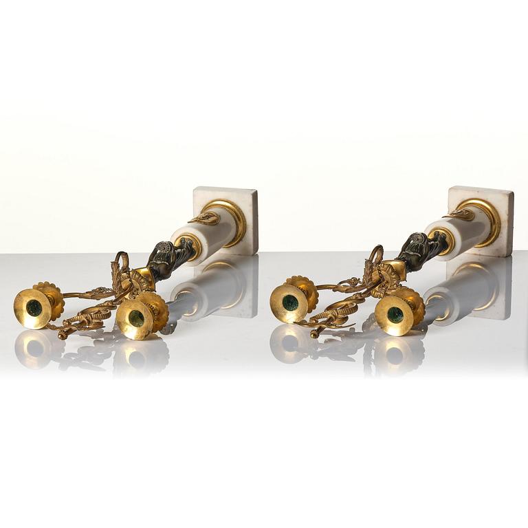 A pair of late Gustavian white marble and bronze candelabra.