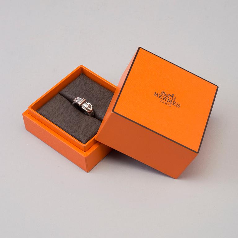 A silver ring by Hermès.