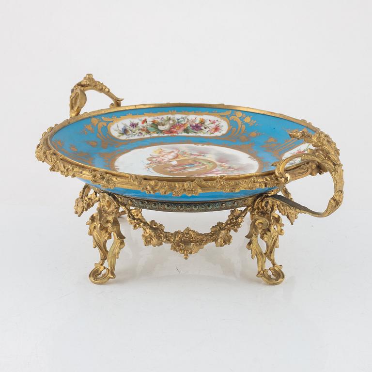 A French porcelain and brass centrepiece, second half of the 19th Century.