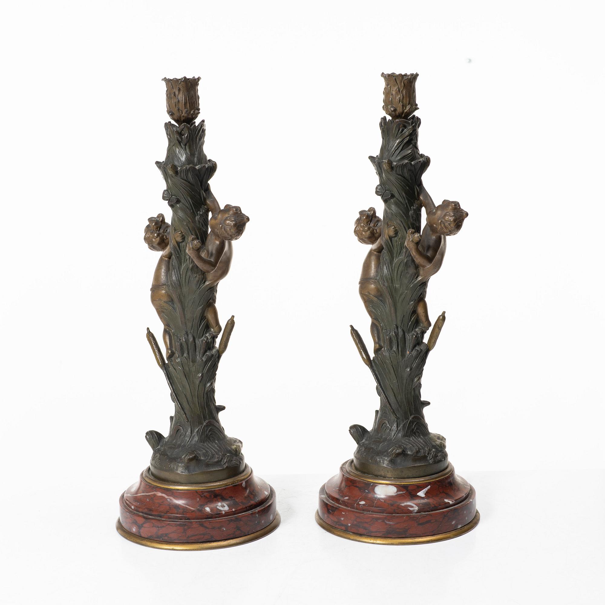 a pair of bronze and marble candle sticks, after a model by Houdon, late 19th century.