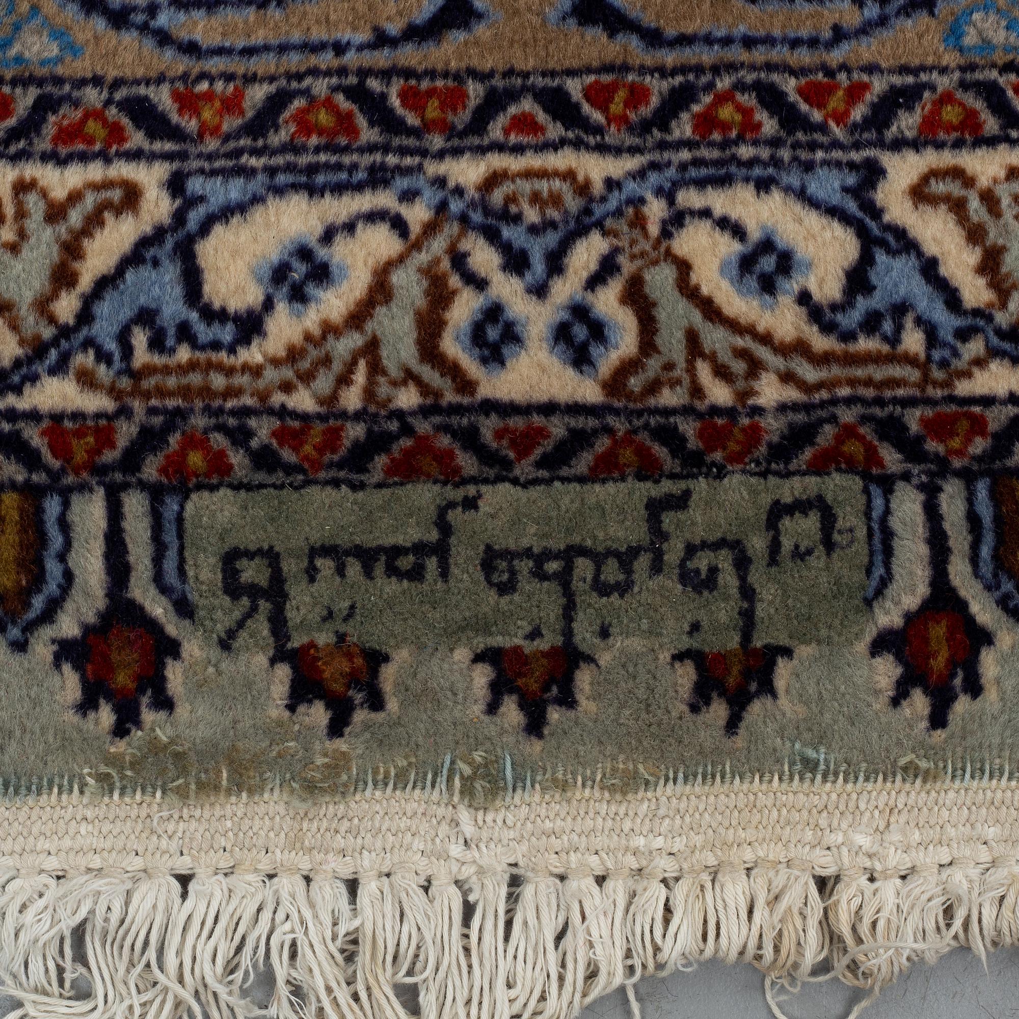 A CARPET, Kashmar, part silk, signed Mosafar Khan, around 344 X 241.