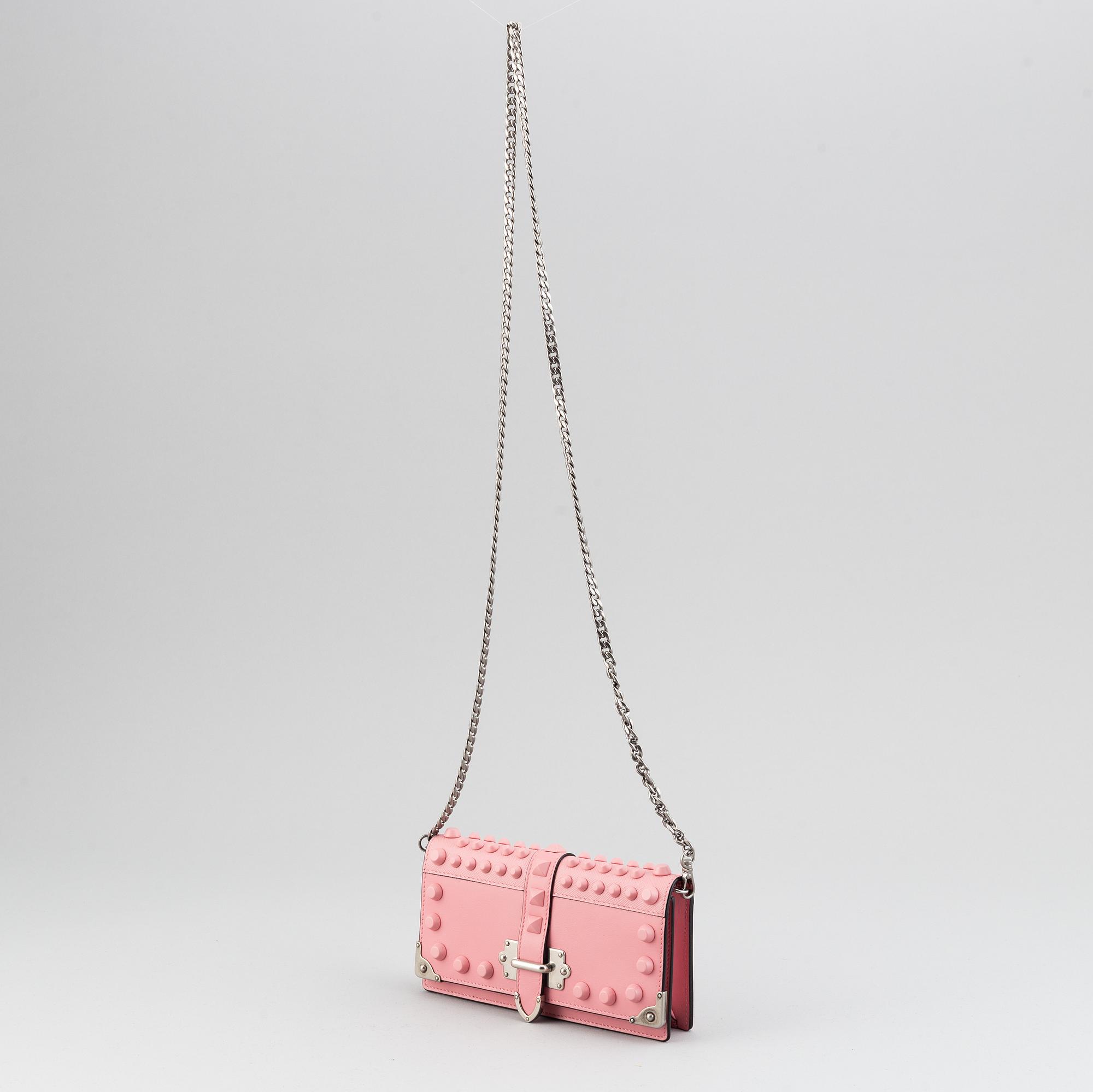 A Prada leather mini bag " Cahier" with metal details and rivets. Marked "Prada Milano". Authenticity card included.