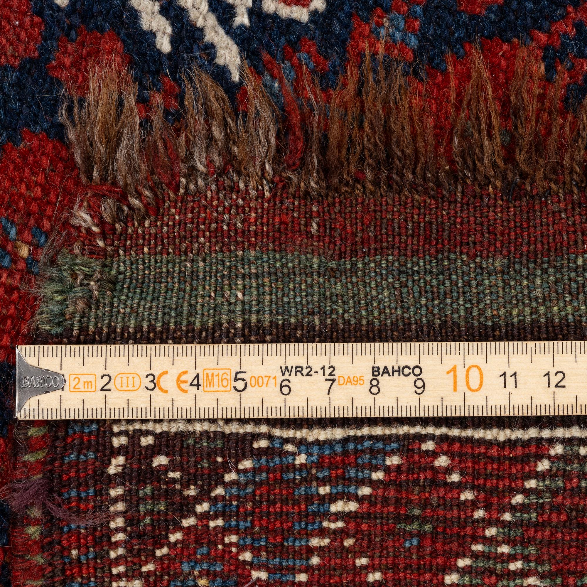 An antique Qashgai rug, 230 x 135 cm.