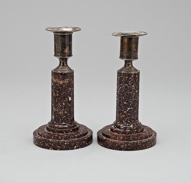 A pair of late Gustavian early 19th Century porphyry and silver candlesticks.