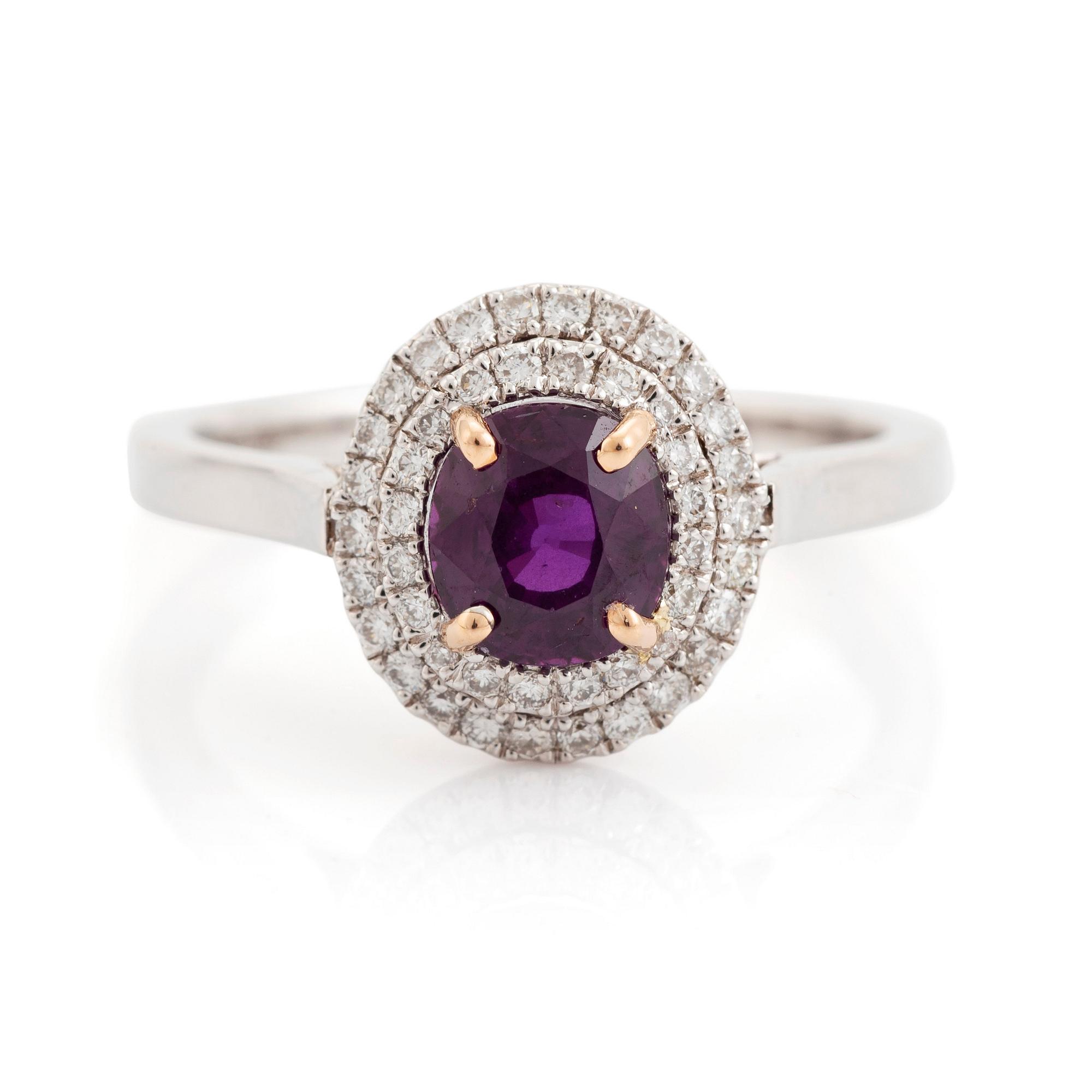An 18K white gold ring set with a faceted ruby.