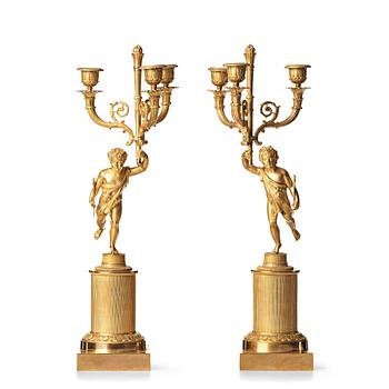 82. A pair of French Empire early 19th century three--light candelabra.