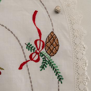 A collection of smaller Christmas tablecloths, runners, and wall hangings, approximately 34 pieces, mid/second half of the 20th century.