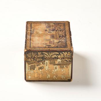 A lacquer tea box and a blanc de chine cup, Qing dynasty 18/19th century.