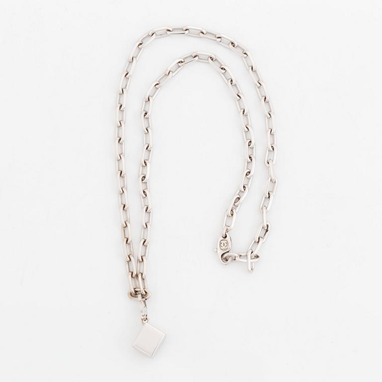 An 18K gold and white gold Cartier necklace with a charm.