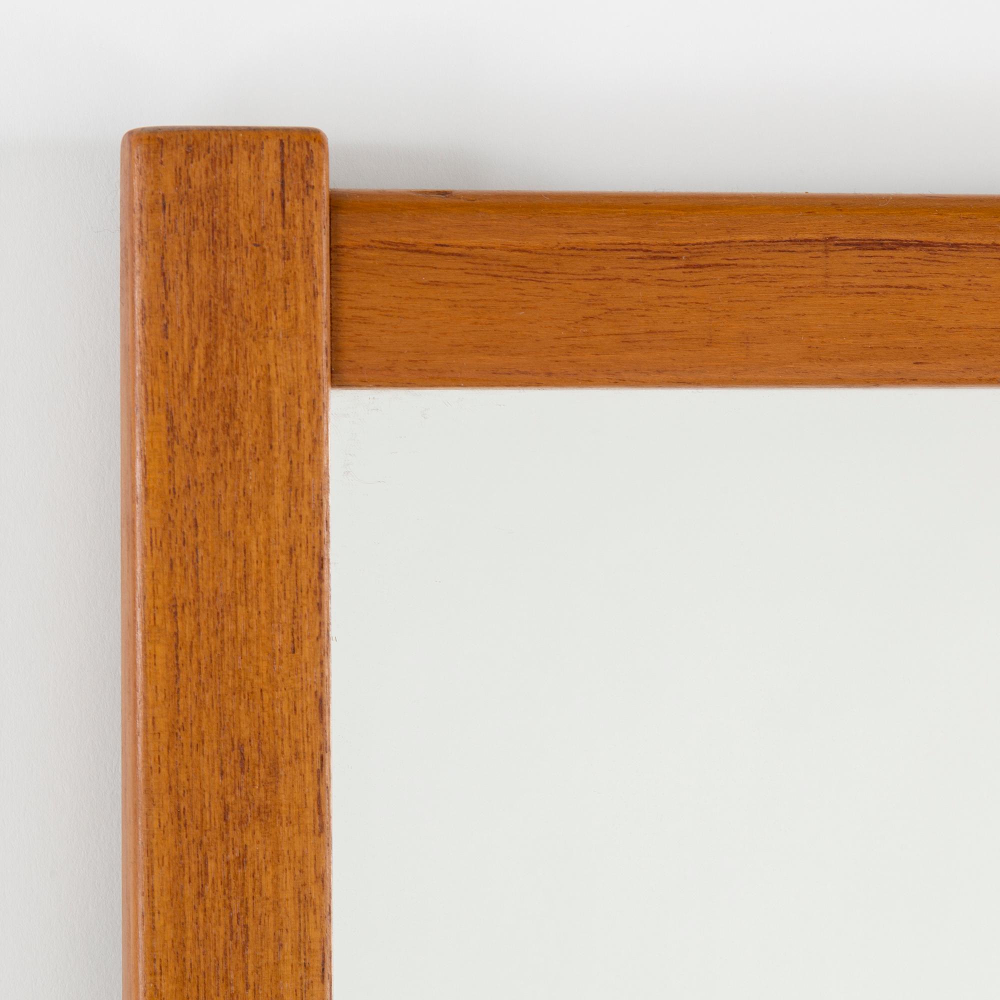 A Swedish teak mirror, Fröseke Nybrofabriken, 1950s / 60s. Signed with label.