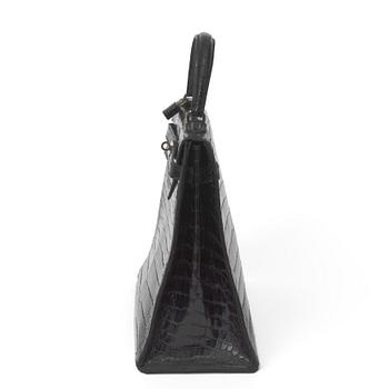 A 1960s/70s black crocodile leather handbag "Kelly" by Hermès.