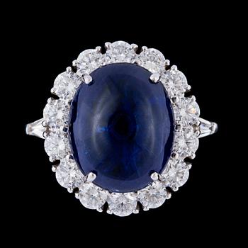 1292. A cabochon cut blue Burmese sapphire, 10.57 cts, and brilliant cut diamond ring.