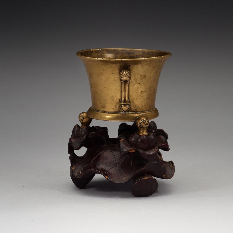 A gilt copper alloy tripod censer, Qing dynasty, presumably 18th Century with Xuandes six character mark.