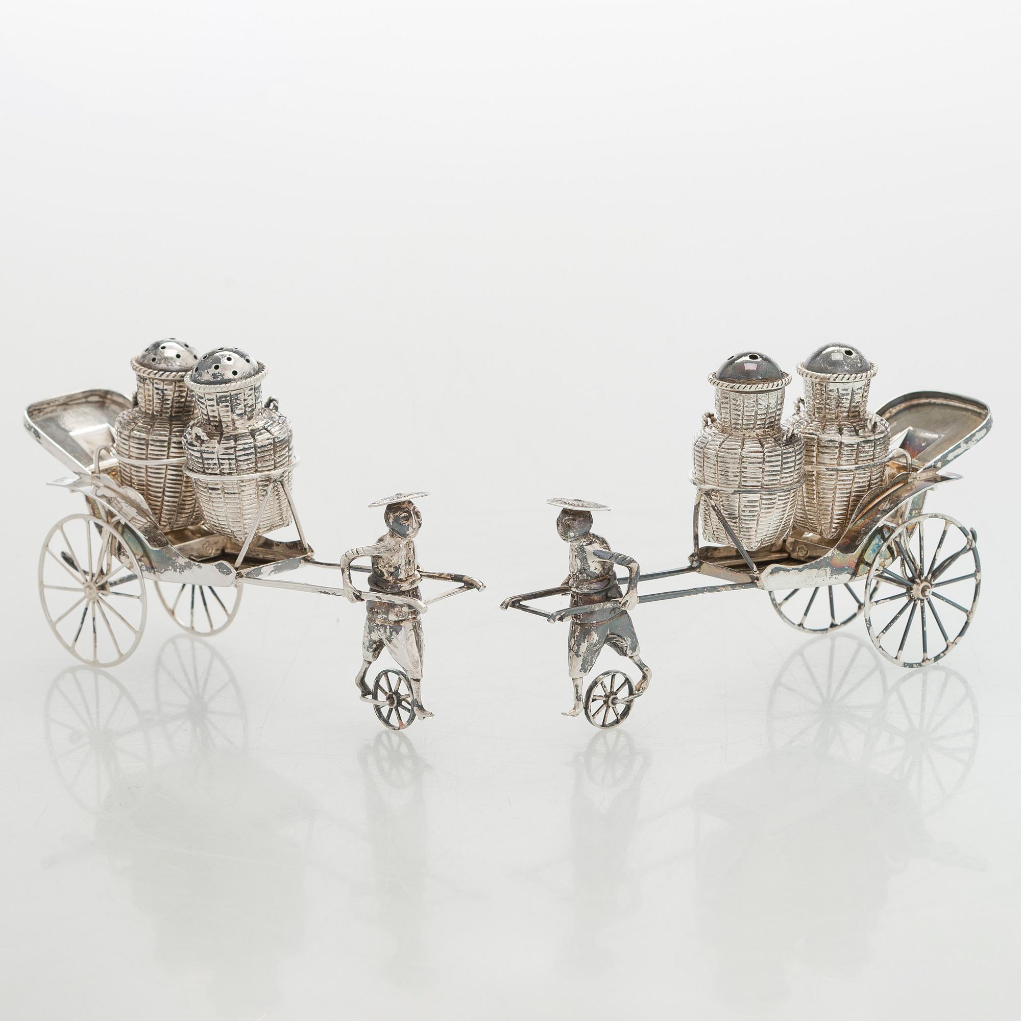 Four shakers in a pair of miniature rickshaws, sterling silver, maker's mark of Wai Kee, Hong Kong.