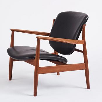 Finn Juhl, a teak and black leather 'model 136' easy chair, France & Daverkosen, Denmark 1950-60s.