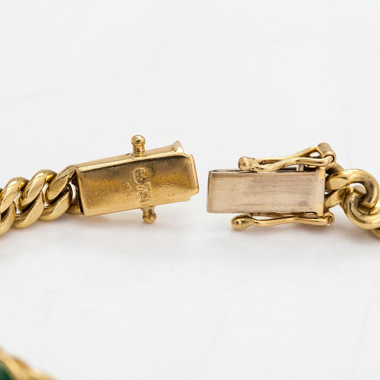 An 18K gold curb link bracelet with cabochon-cut green garnets.