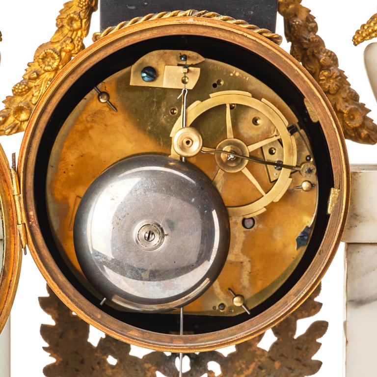 A Louis XVI gilt bronze and white marble mantel clock.