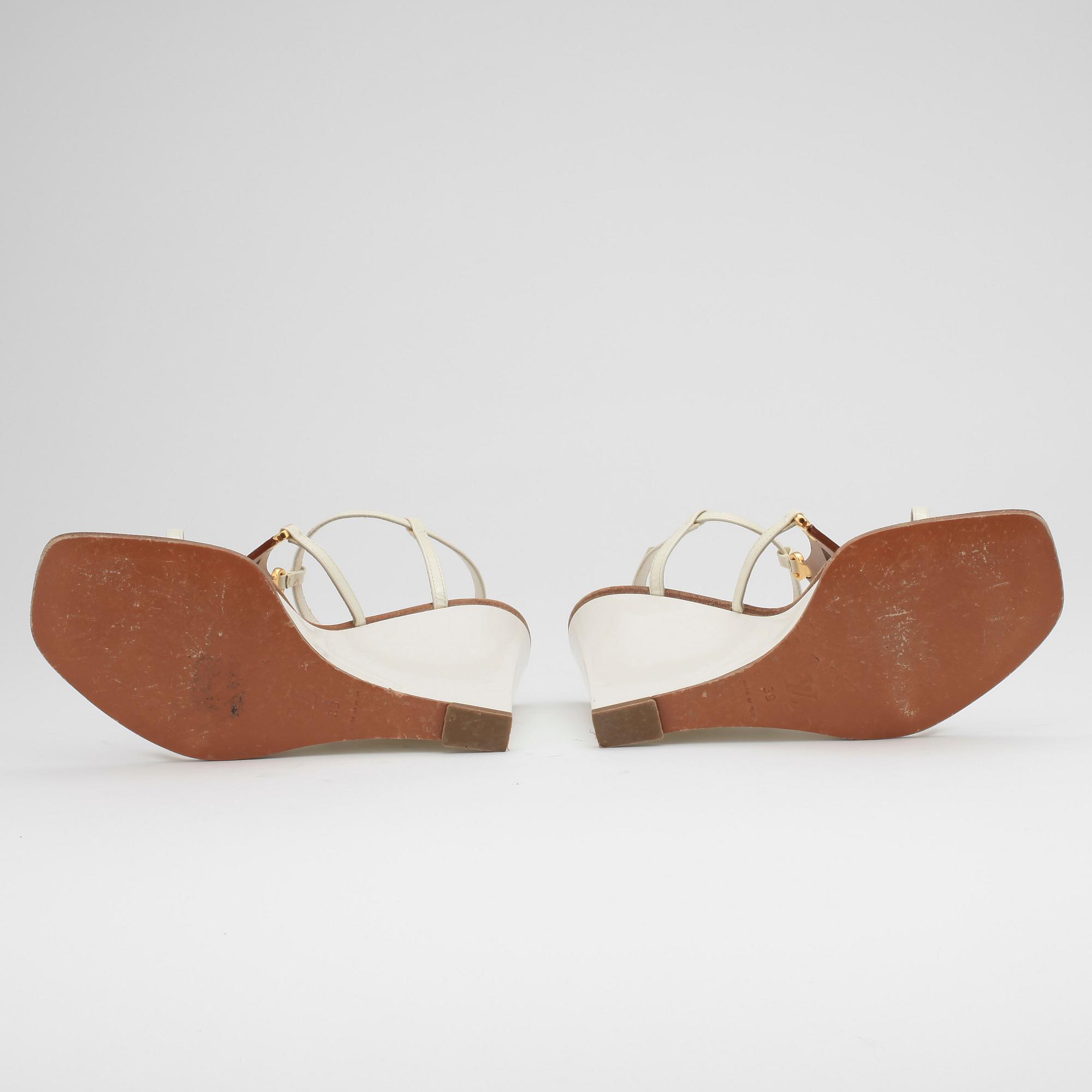 LOUIS VUITTON, a pair of white wedge heel sandalettes.