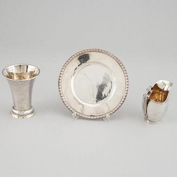 Beaker, silver 1835, cream-jug, silver 1826 and bread-plate, silver 1952.