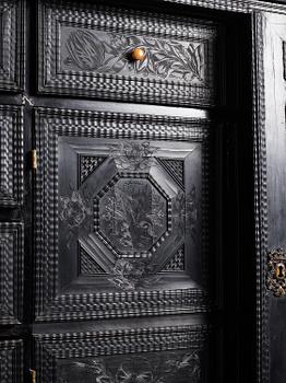 A Louis XIV and Louis XIV-style carved ebony, ivory and tortoiseshell-inlaid cabinet on stand, 17th and 19th century.