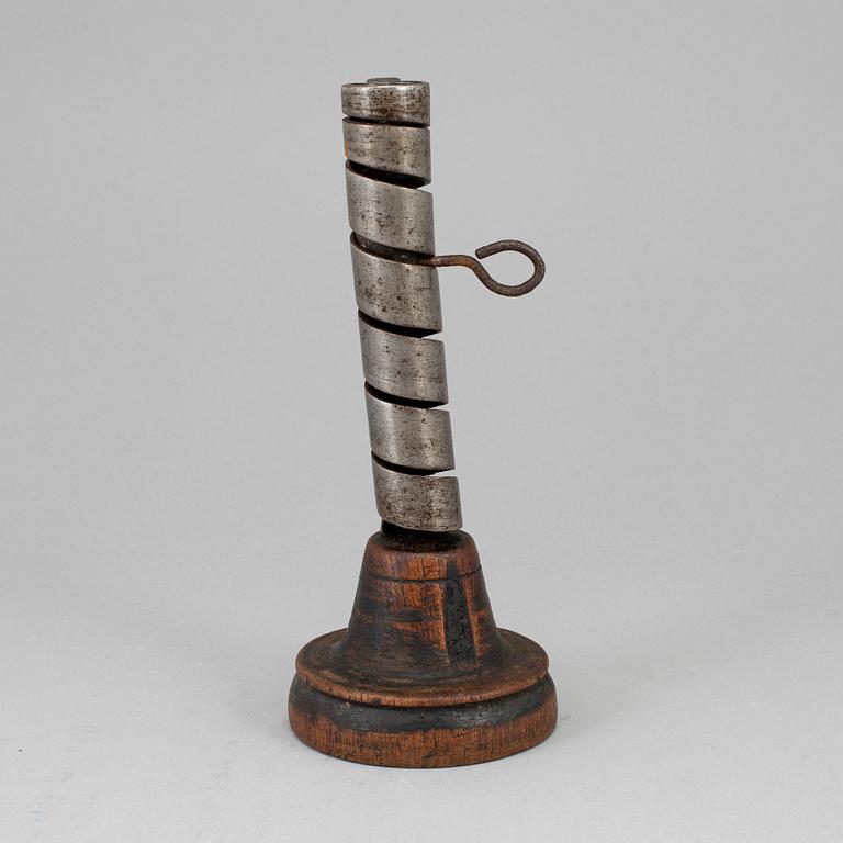 An 18th century wood and iron candlestick.