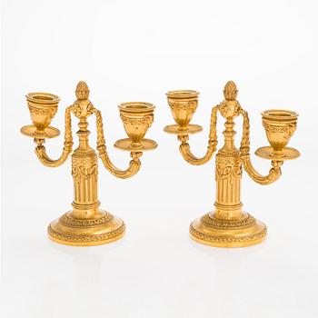 A. Rislef & Carré, a pair of brass candelabra, Paris, around 1900.