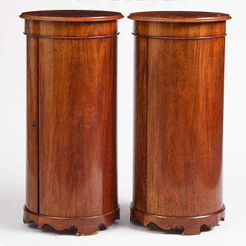 A pair of late Empire mahogany column cabinets, mid 19th Century.