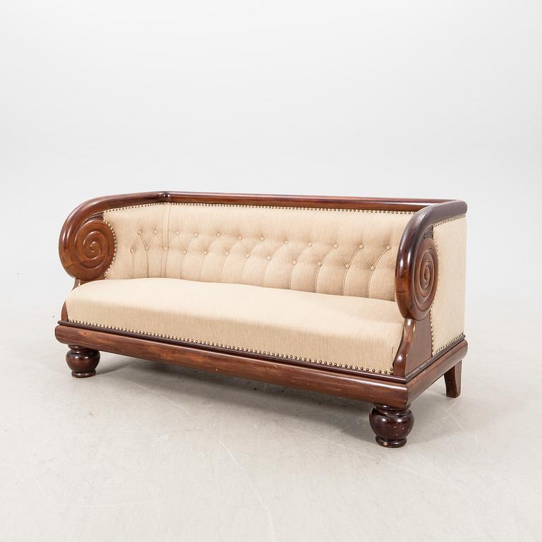 An early 1900s Art deco walnut sofa.