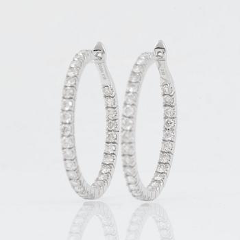 A pair of diamond hoop earrings, 2.89 cts in total, according to engraving.