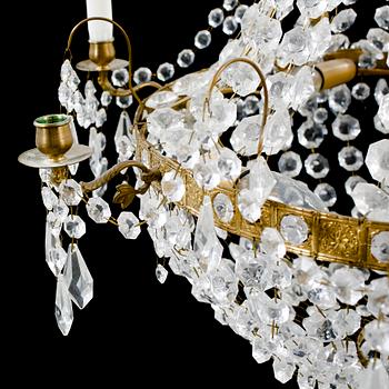 A 20th century chandelier in the Empire style. Height ca 96 cm.