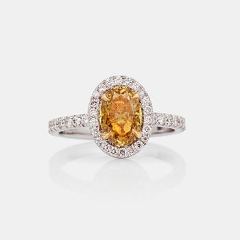 A fancy greenish-brownish-yellow 1.21 ct diamond ring with pavé-set brilliant-cut diamonds, total carat weight 0.42 ct.