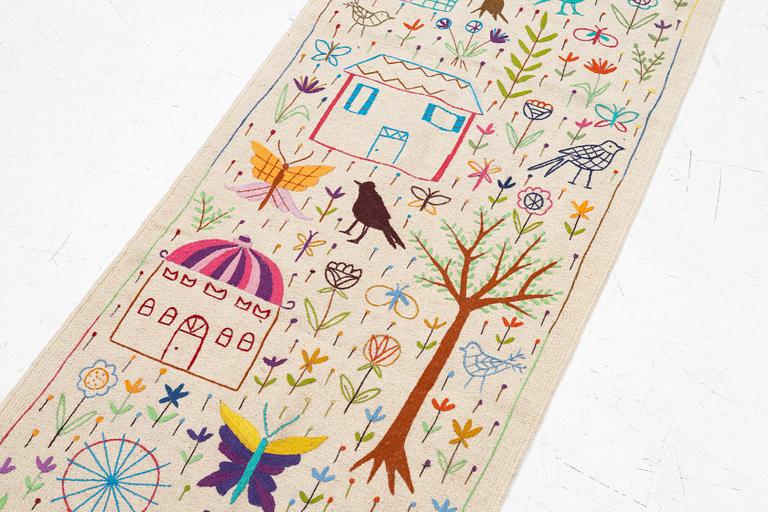 A hand-embroidered Kelim runner, c. 292 x 85 cm.