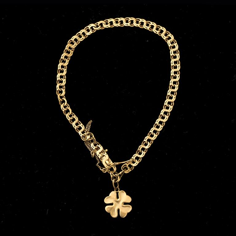 ARMLÄNK,  18 k guld med berlock. G A Dahlgren AB Malmö, 1940. Bolidenguld. Vikt ca 5,5 g.