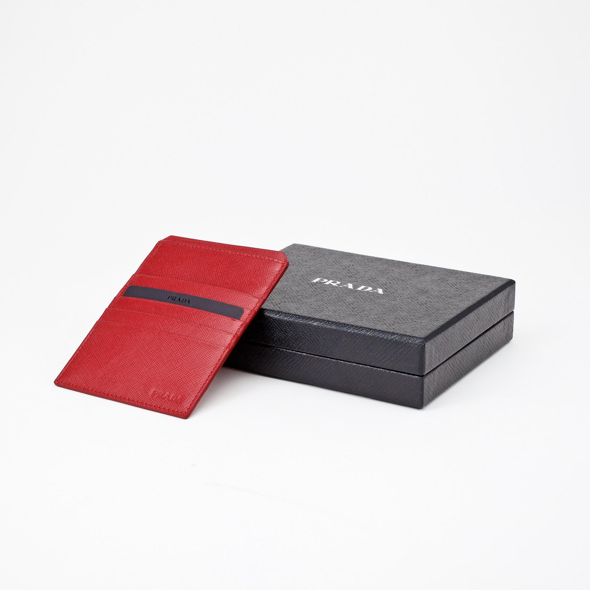 PRADA, a red leather credit card holder.