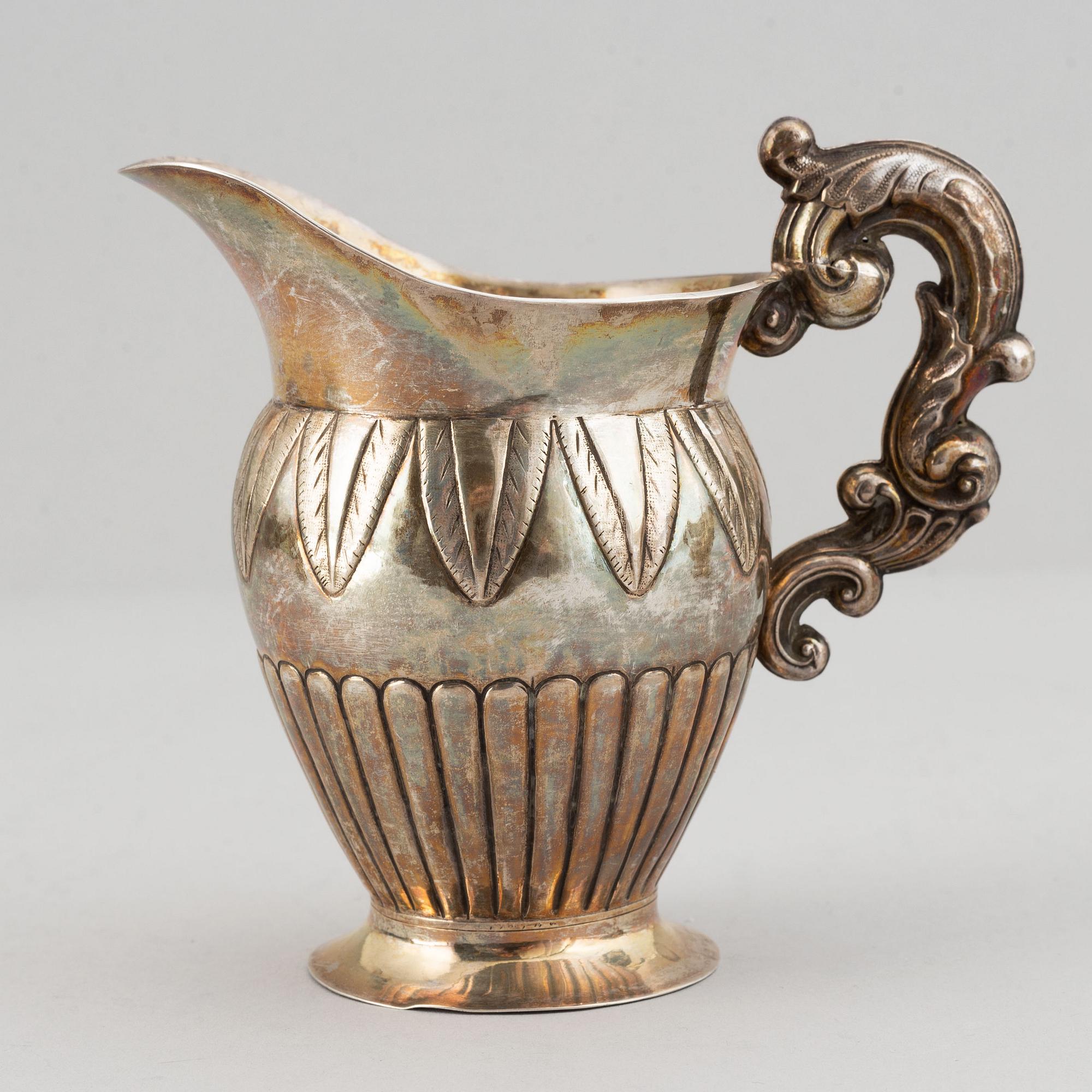 A mixed lot of two 19th century silver and parcel-gilt creamers and a coffee-pot.
