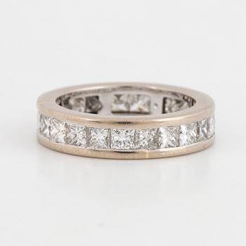 An 18K white gold eternity ring set with princess-cut diamonds.