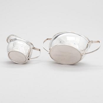 An early 19th-century, sterling silver sugar bowl, mark of Elizabeth Morley, and a cream jug, marked A.B, London 1808.