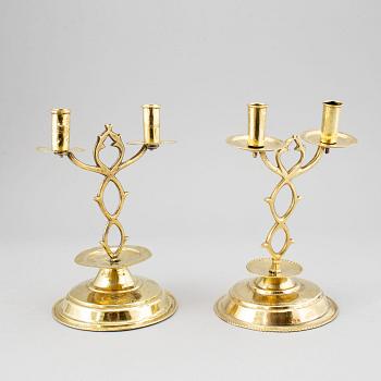 A pair of brass candelabra for two candles "Blekingestakar and a pair of brass cups, 1800/1900.