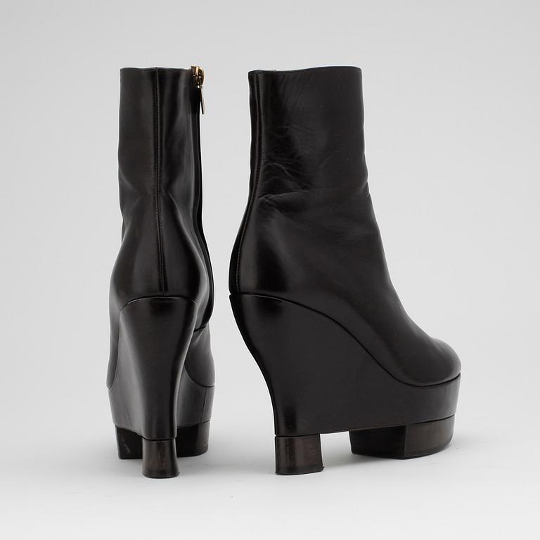 YVES SAINT LAURENT, a pair of brown leather wedge heeled platform boots.