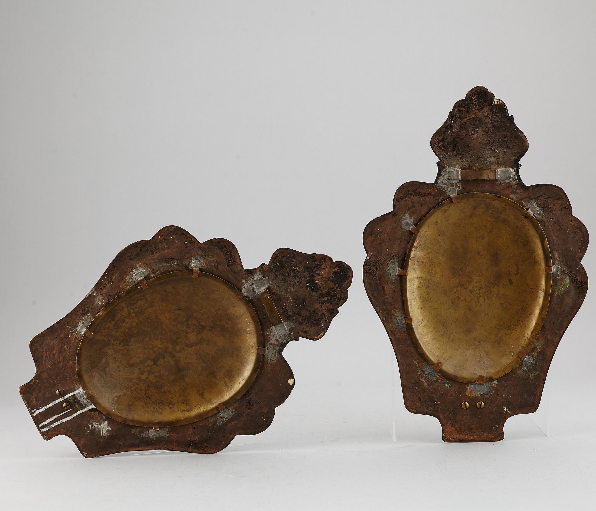 A pair of bronze and brass wall sconces from the early 20th century.