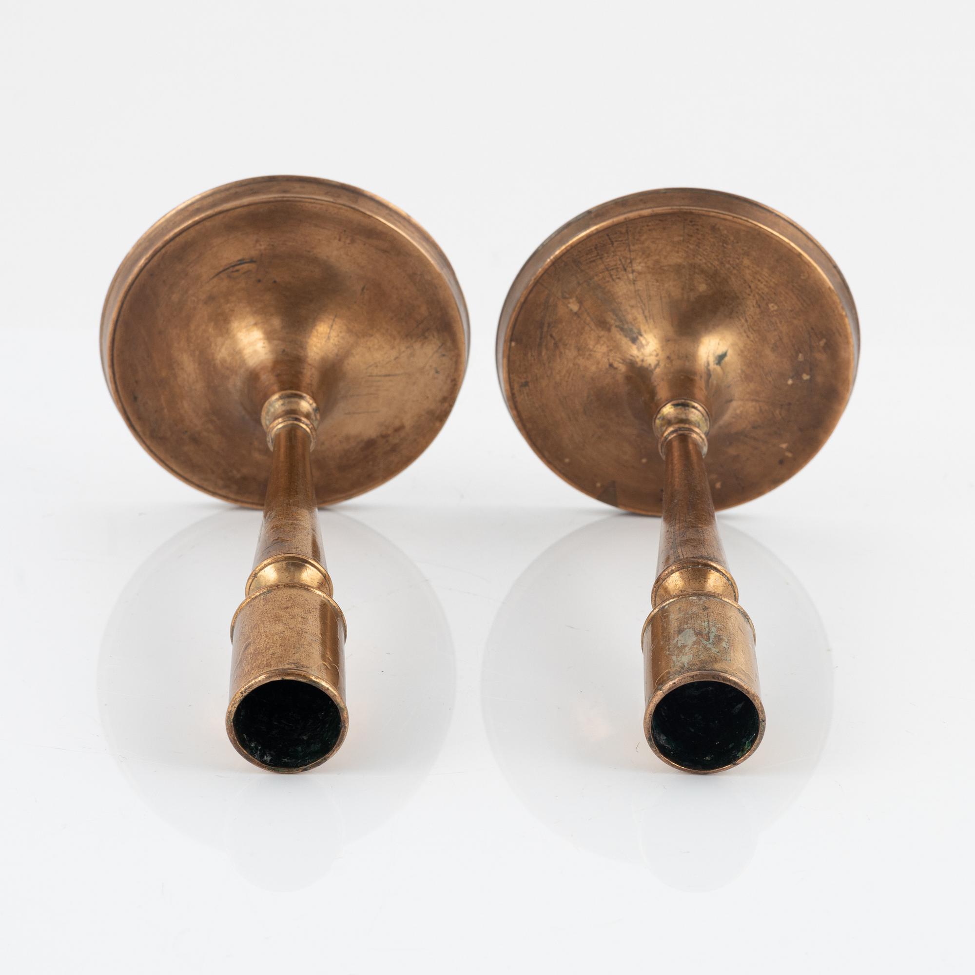 A pair of bronze candlesticks, 18th Century.