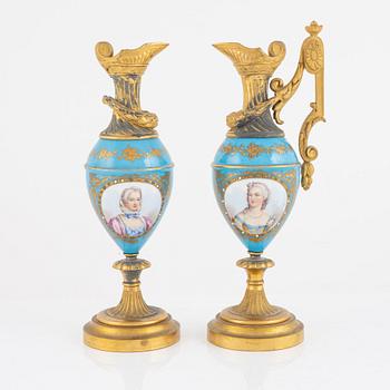 A French mantel clock, two urns and two depicters, second half of the 19th Century.