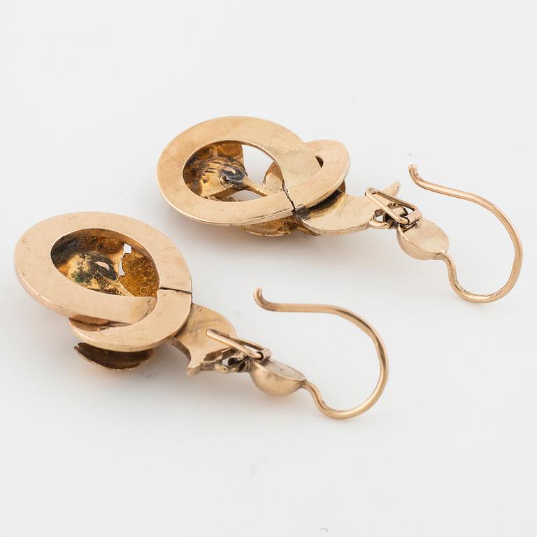 A pair of enamel and rose cut diamond earrings.