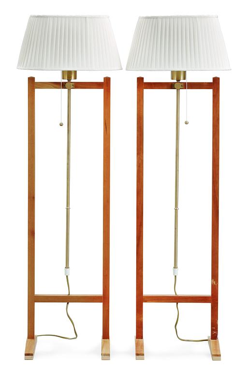 A pair of Josef Frank walnut and brass floor lamp by Svenskt Tenn, model 2548.