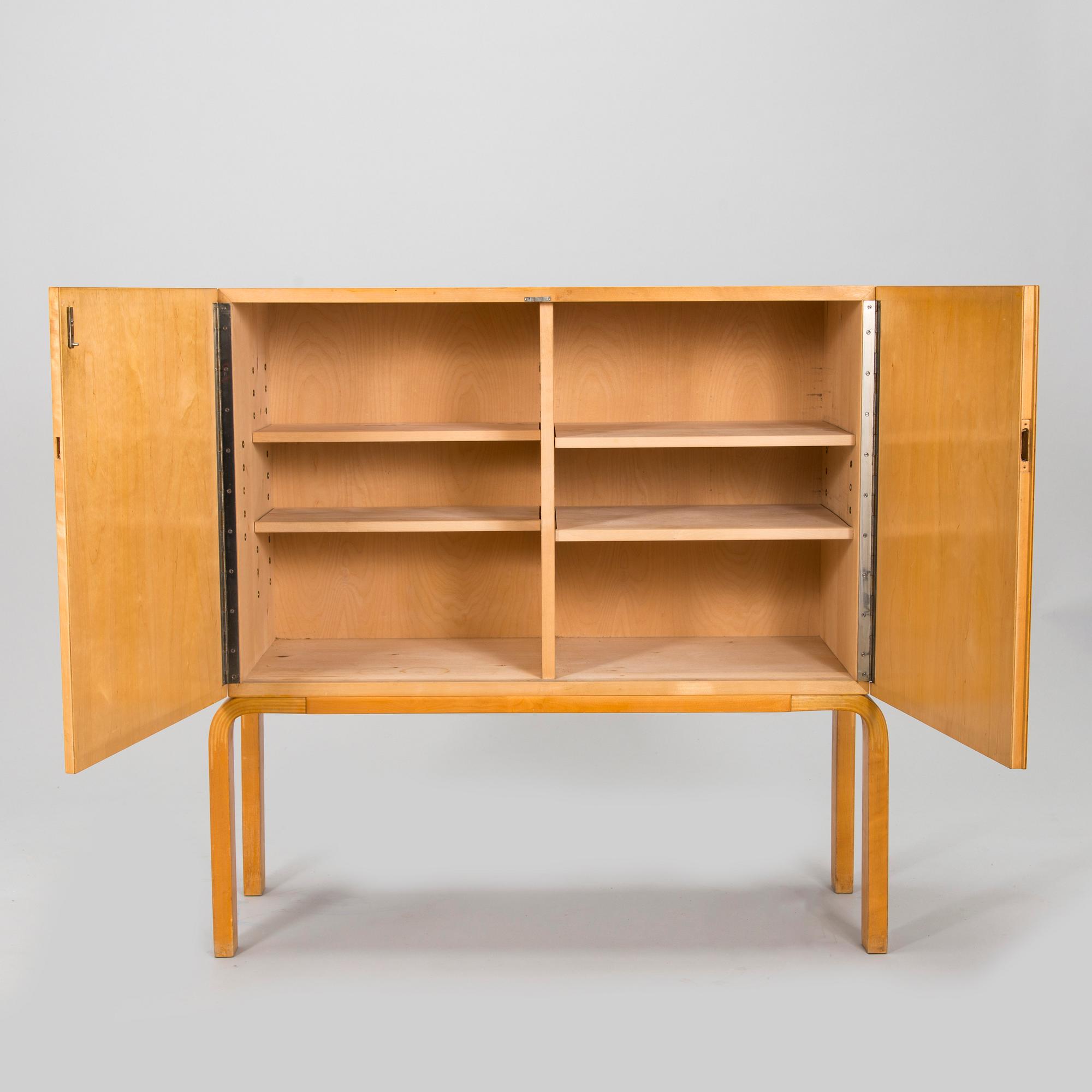 Alvar Aalto, mid-20th century '810' cabinet and a 
'69'chair Oy Huonekalu- ja Rakennustyötehdas Ab.