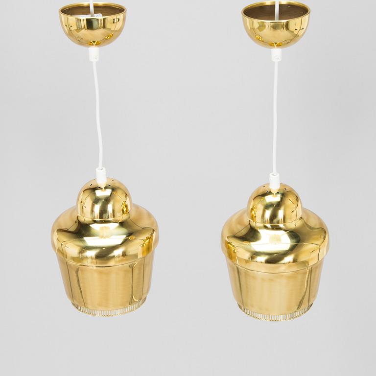Alvar Aalto, A pair of  A 330, 'Golden Bell' pendant lights A330 for Artek, 2000s.