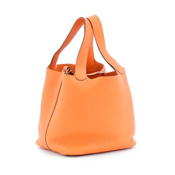 677. HERMÈS, a orange leather handbag, "Picotin lock".