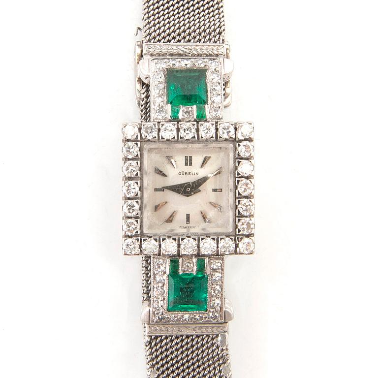 Gübelin bracelet watch in 950 platinum with round brilliant-cut and single-cut diamonds as well as step-cut emeralds.